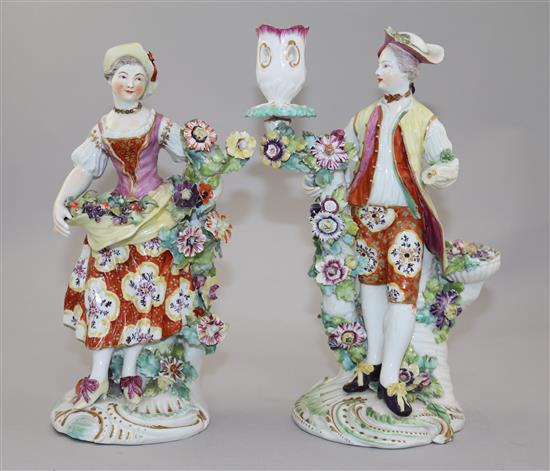 A pair of Derby candlestick figures of a gentleman and a lady, 24cm, damaged